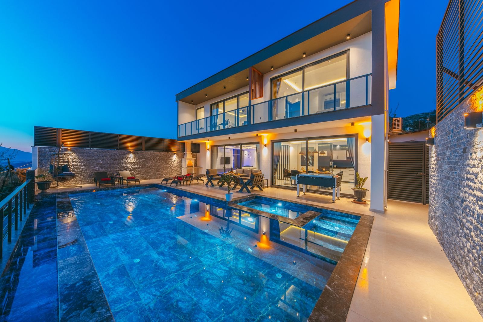 Backyard pool and modern home at dusk