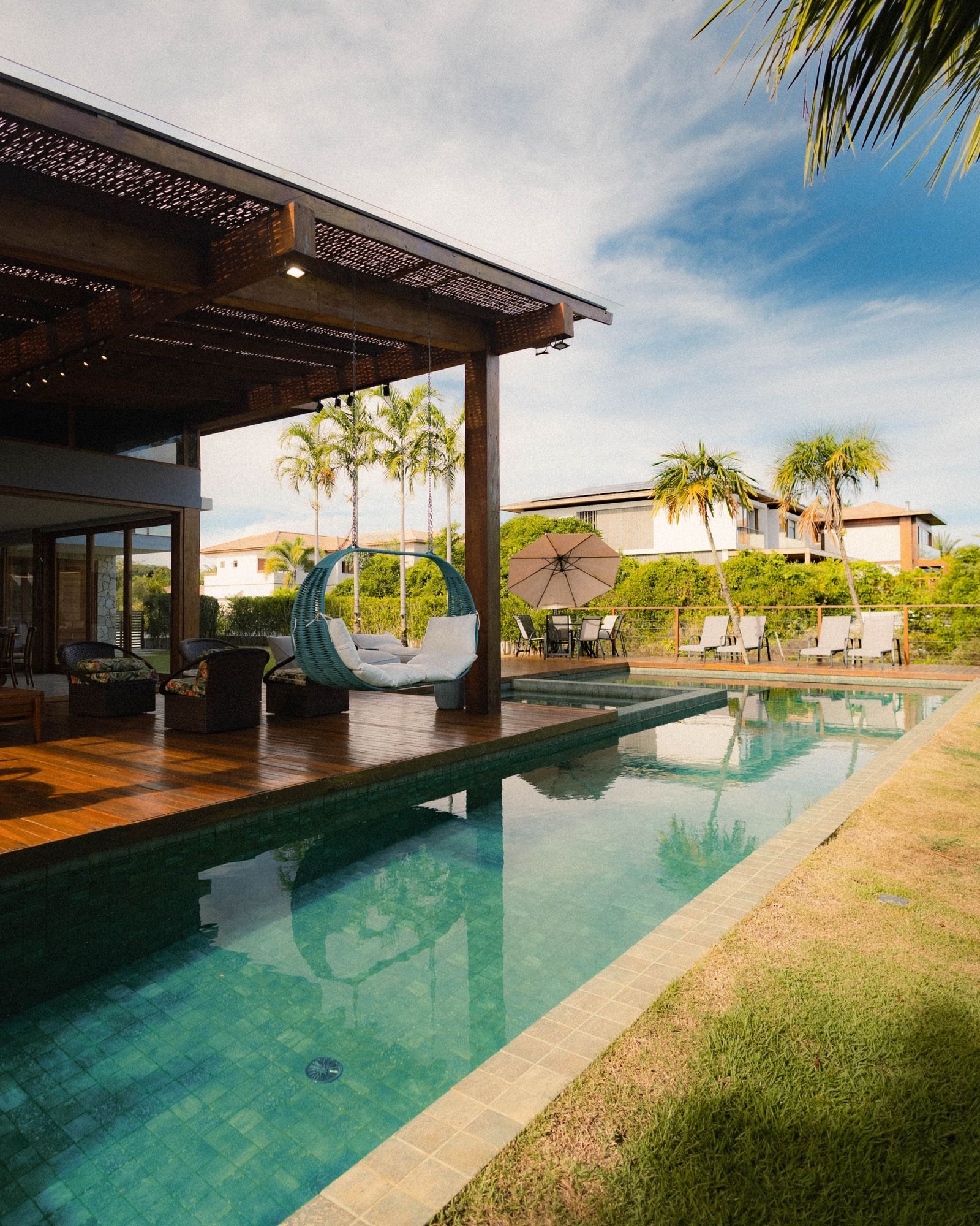 Long inground lap pool with a covered patio